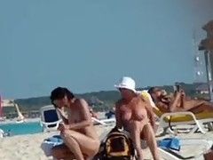 Naked grown-up wife gets a stranger to rub sun lotion on her back, fusty boobs and little teem visible.